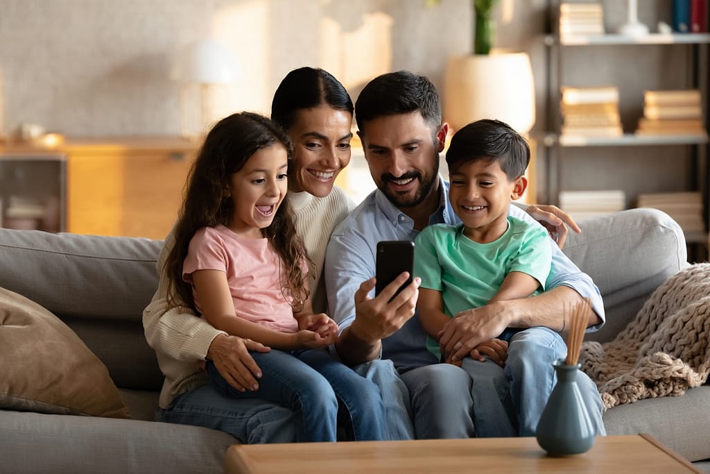Familia hispana feliz ahorrando dinero con servicio de luz prepagada en Texas sin depósito